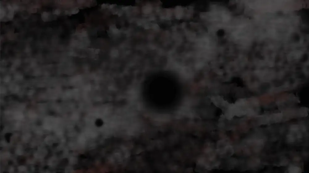 A black and grey composition of fuzzy patches with a blurred circle toward the center